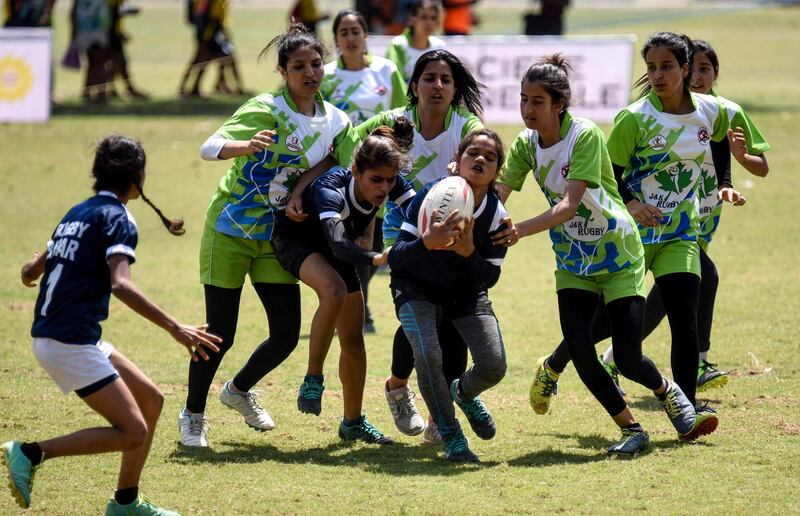 In this photo taken on June 14, 2019, Indian Junior rugby players take part in a match during the 2019 Junior National Rugby 7s Championship at the Panjab University in Chandigarh. - In the 1870s when the Calcutta Rugby Football Club started charging for drinks, interest among British colonials waned and it was disbanded, leaving 270 silver rupees in the kitty, so the story goes. (Photo by STR / AFP) / TO GO WITH RugbyU-WC-2019-India-IND,FOCUS by Simon STURDEE