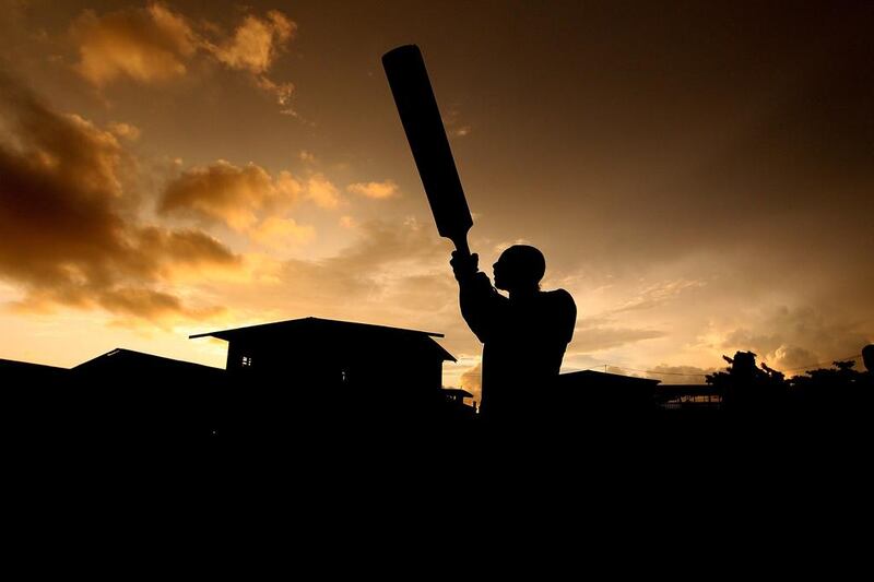 A boy from the village of Hanuabada bats during a game of cricket in the streets in Port Moresby, Papua New Guinea. Chris Hyde / Getty Images