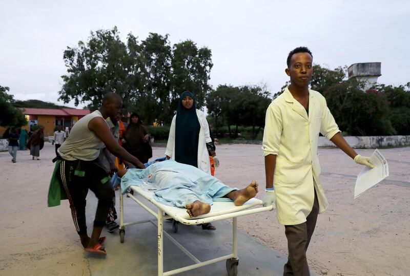Paramedics and civilians carry an injured person on a stretcher at Madina hospital after a blast at the Elite Hotel in Lido beach in Mogadishu, Somalia. Reuters