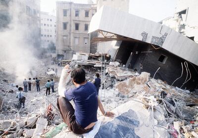 (FILES) Picture dated 20 August 1982 of a man sitting on rubbles in a desolated area of west Beirut. (Photo by DOMINIQUE FAGET / AFP FILES / AFP)