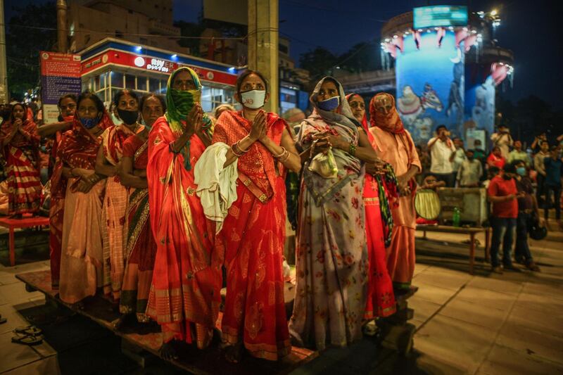 Hindu women gather to attend evening prayers at the Dashashwmedh Ghat, along the banks of the Ganges river, in Varanasi, India. Getty Images