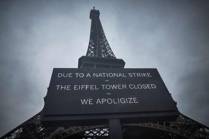 A board informs visitors that the Eiffel Tower is closed after staff went on strike to protest against authorities' financial management of the monument. AFP