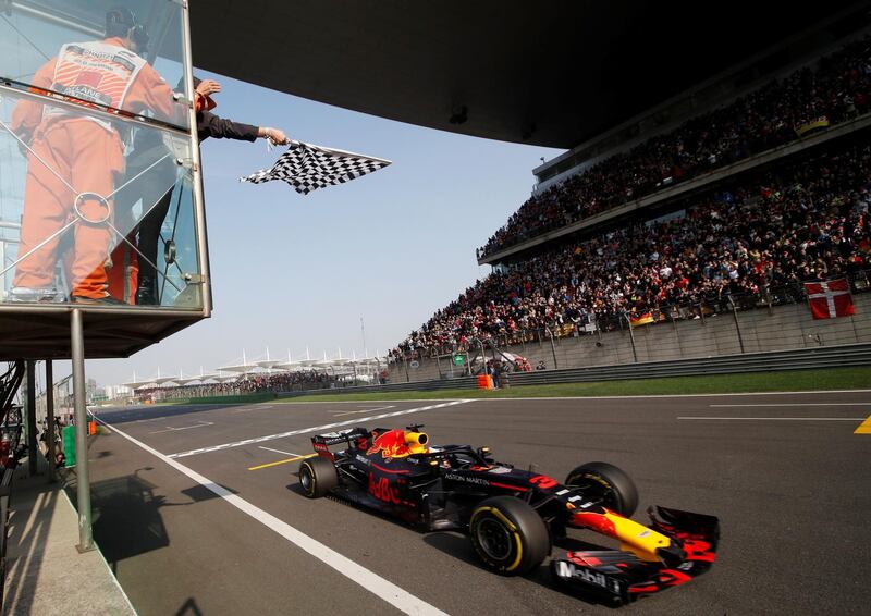 TOPSHOT - Red Bull's Australian driver Daniel Ricciardo crosses the checkered flag to win the Formula One Chinese Grand Prix in Shanghai on April 15, 2018. / AFP PHOTO / POOL / -