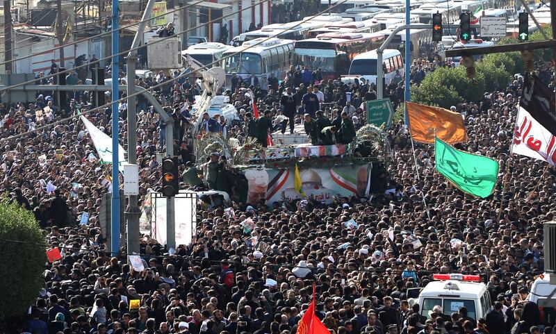 A large crowd surrounds the coffins of Qassem Suleimani and Abu Mahdi Al Muhandis as they are transported atop a vehicle after their arrival at Ahvaz International Airport in southwestern Iran.  AFP