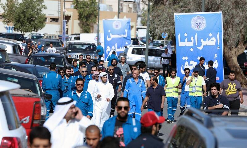 Kuwaiti oil workers arrive at the union headquarters in Al Ahmadi, 35km south of Kuwait City, to protest alleged pay cuts and plans to privatise parts of the oil sector. Yasser Al Zayyat / AFP Photo