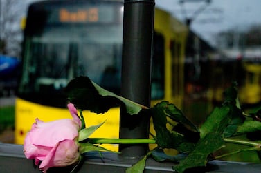 A tram passes a rose at the site of a shooting incident in a tram in Utrecht, Netherlands, Tuesday, March 19, 2019. A gunman killed three people and wounded others on a tram in the central Dutch city of Utrecht Monday March 18, 2019. AP