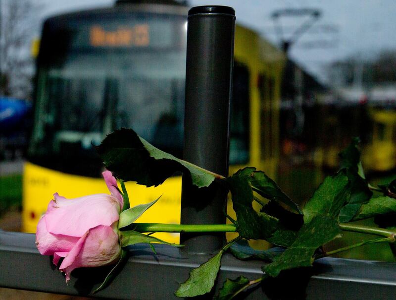 A tram passes a rose at the site of a shooting incident in a tram in Utrecht, Netherlands, Tuesday, March 19, 2019. A gunman killed three people and wounded others on a tram in the central Dutch city of Utrecht Monday March 18, 2019. (AP Photo/Peter Dejong)