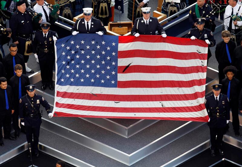 The flag that flew over the World Trade Center on 9/11 is seen during ceremonies marking the 10th anniversary of the 9/11 attacks on the World Trade Center, in New York, September 11, 2011. REUTERS/Mark Blinch (UNITED STATES - Tags: ANNIVERSARY DISASTER TPX IMAGES OF THE DAY) *** Local Caption ***  WTC114_SEPT11-_0911_11.JPG