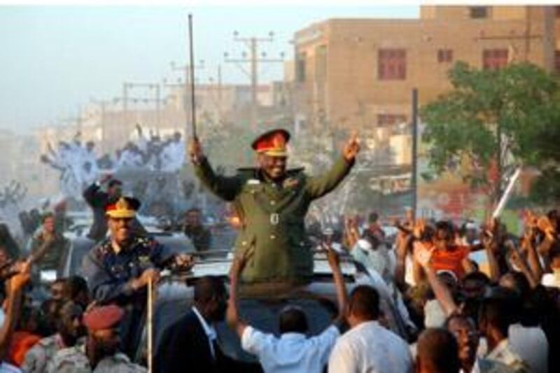 Sudanese President Omar al-Beshir parades in the streets of Khartoum and waves to supporters on March 4, 2009 after the International Criminal Court issued a warrant for his arrest over alleged war crimes and crimes against humanity. A defiant Sudan vowed it would not work with the ICC as thousands of demonstrators massed in Khartoum to protest at its arrest warrant against Beshir. The warrant is the first ever issued against a sitting head of state. AFP/PHOTO/STR *** Local Caption ***  Nic344978.jpg