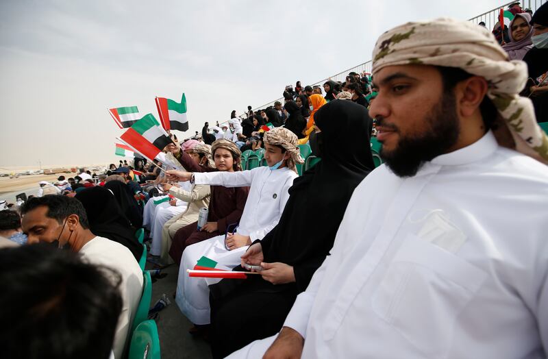 People wave UAE flags. EPA