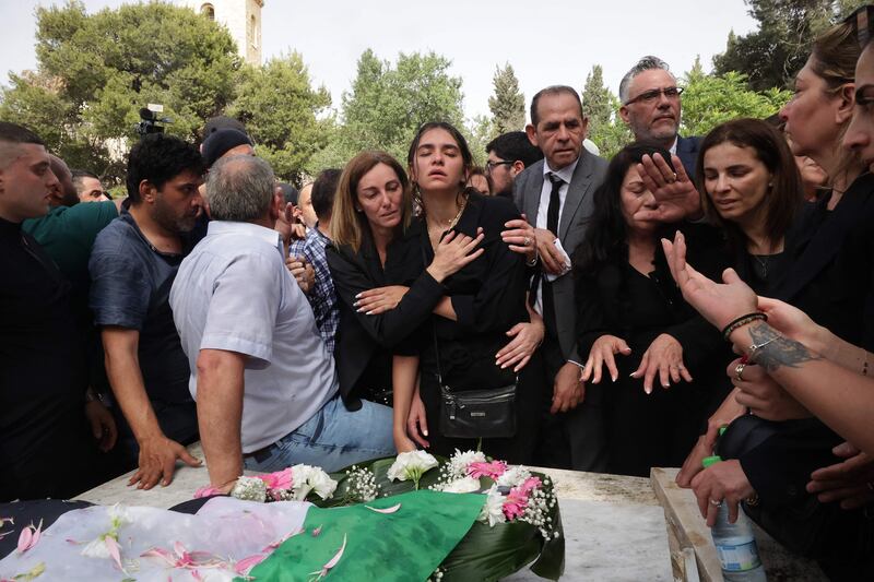 Mourners react during the burial of the veteran journalist at the Mount Zion Cemetery outside Jerusalem's Old City. AFP