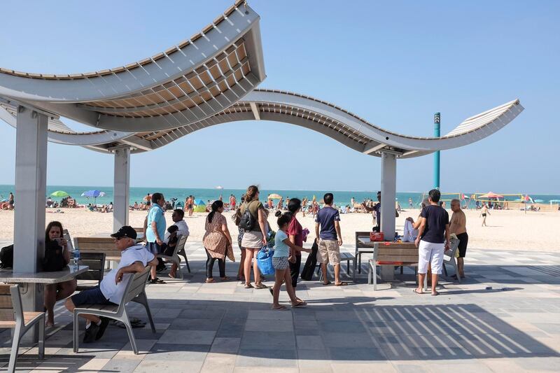 DUBAI, UNITED ARAB EMIRATES. 18 NOVEMBER 2018. Residents and visitors to Dubai enjoy the public holiday on the birthday of Prophet Mohammad (PBUH), also known as Eid Al Mawlid an Nabawi, in the sunshine on Kite Surf Beach. Beach goers enjou the breach while taking in the sights and sounds from the shade. (Photo: Antonie Robertson/The National) Journalist: None. Section: National.