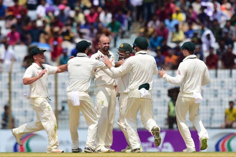 Australian cricketers congratulate teamamte Nathan Lyon (2R) after the dismissal of Bangladeshi cricketer Sabbir Rahman tries to makes his ground during the fourth day of the second cricket Test between Bangladesh and Australia at Zahur Ahmed Chowdhury Stadium in Chittagong on September 7, 2017. / AFP PHOTO / Munir UZ ZAMAN