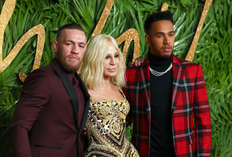 Italian designer Donatella Versace, British Formula One driver Lewis Hamilton and Conor McGregor at the British Fashion Awards at the Royal Albert Hall in London on December 4, 2017.