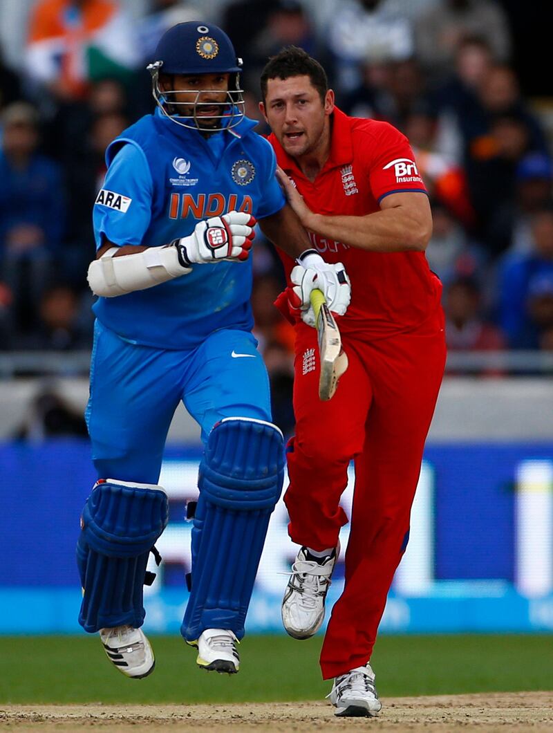 England's Tim Bresnan (R) bumps into India's Shikhar Dhawan during their ICC Champions Trophy final match at Edgbaston cricket ground in Birmingham, central England, June 23, 2013. REUTERS/Darren Staples   (BRITAIN - Tags: SPORT CRICKET) *** Local Caption ***  DST13_CRICKET-CHAMP_0623_11.JPG