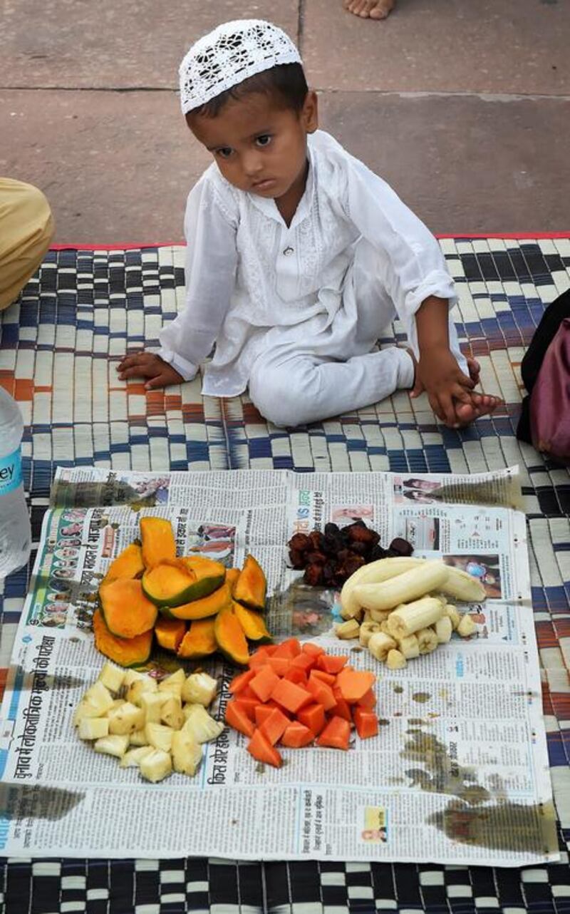 An Indian Muslim boy waiting to begin his Iftar meal at Jama Masjid, Old Delhi, on the first Friday of Ramadan, July 4, 2014. Harish Tyagi/EPA