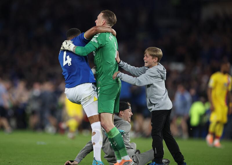 Everton's Jordan Pickford, Mason Holgate and Everton fans celebrate. Reuters