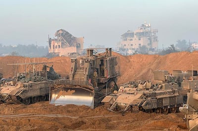 Israeli tanks and a bulldozer inside the Gaza Strip as battles between Israeli forces and Palestinian militants continued on Sunday. Israeli army / AFP