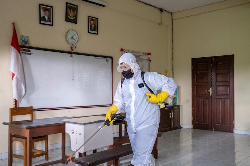 An official sprays disinfectant inside a school amid the ongoing coronavirus pandemic in Denpasar, Bali, Indonesia. EPA