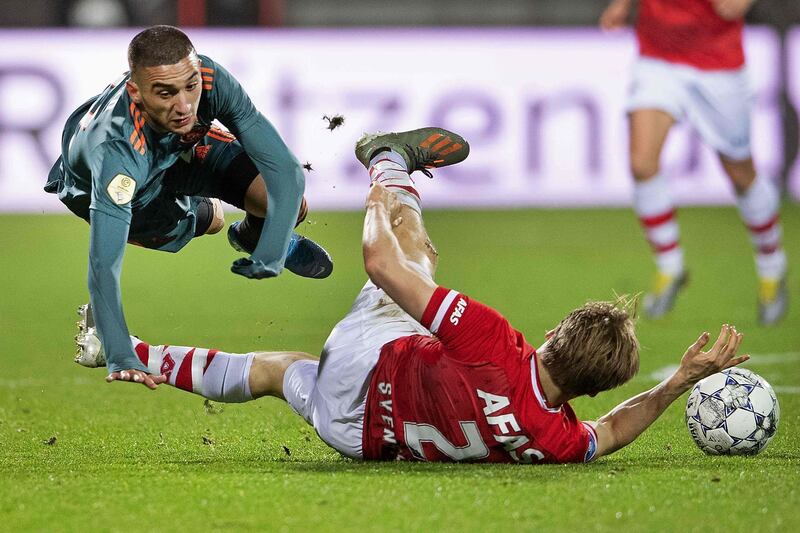 Alkmaar's Jonas Svensson, right, fights for the ball with Ajax's Hakim Ziyech. AFP