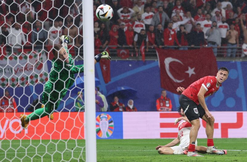 Turkey goalkeeper Mert Gunok saves a shot late in the game from Christoph Baumgartner of Austria with a brilliant reflex parry. EPA