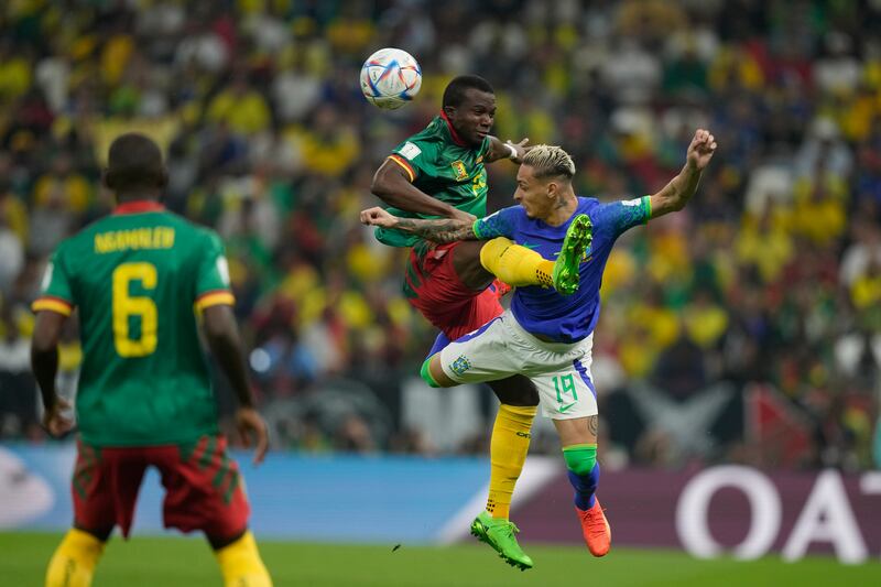 Cameroon's Tolo Nouhou, left, jumps to a ball with Brazil's Antony, right, during the World Cup group G soccer match between Cameroon and Brazil, at the Lusail Stadium. AP Photo