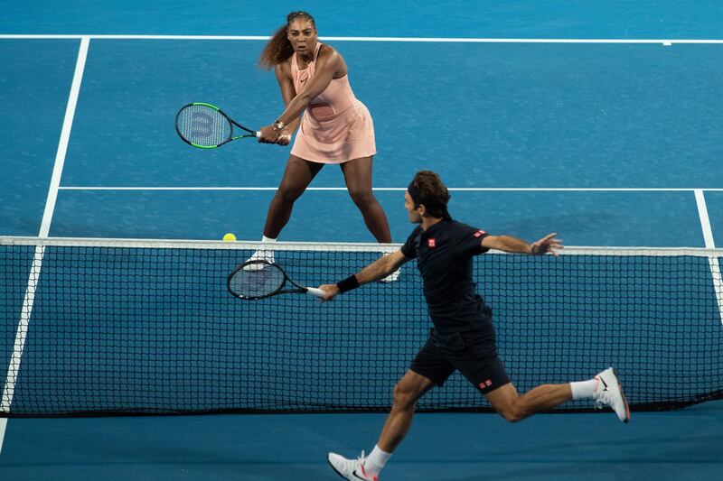 Serena Williams of the USA and Roger Federer of Switzerland in action during the mixed doubles match. EPA