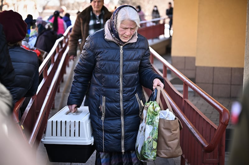 A woman carrying an animal in a pet basket arrives in Przemysl, Poland, on March 23, 2022, after a train journey from Ukraine. Getty