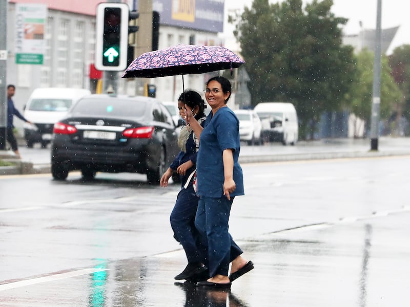 People using umbrellas during the rain in Dubai. Pawan Singh / The National 