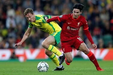 Norwich City's English midfielder Kieran Dowell (L) vies with Liverpool's Japanese midfielder Takumi Minamino during the English League Cup third round football match between Norwich City and Liverpool at Carrow Road Stadium in Norwich, eastern England, on September 21, 2021.  (Photo by Adrian DENNIS / AFP) / RESTRICTED TO EDITORIAL USE.  No use with unauthorized audio, video, data, fixture lists, club/league logos or 'live' services.  Online in-match use limited to 120 images.  An additional 40 images may be used in extra time.  No video emulation.  Social media in-match use limited to 120 images.  An additional 40 images may be used in extra time.  No use in betting publications, games or single club/league/player publications.   /  