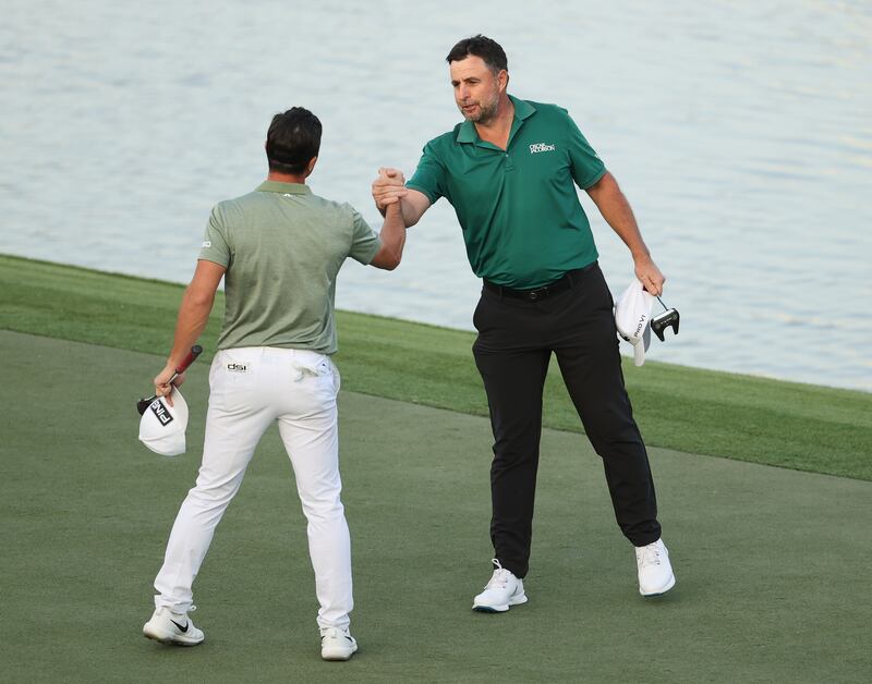 Richard Bland shakes hands with Viktor Hovland after the Norwegian won the play-off in Dubai. Getty