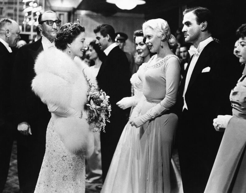 The queen with US actress Jayne Mansfield and British actor Stanley Baker at the Odeon Theatre in London. AP