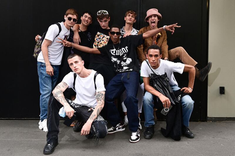 Models pose after the Dolce & Gabbana men's show in Milan on June 19, 2021. AFP
