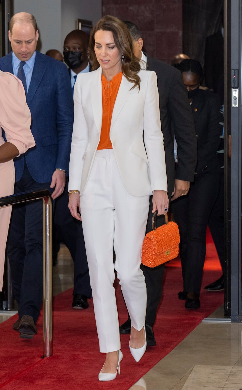 Duchess of Cambridge, in a white Alexander McQueen
suite and orange Ridley London blouse, attends a meeting with the Prime Minister of Jamaica on March 23. Getty Images