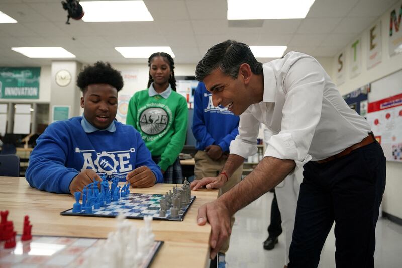 Rishi Sunak is shown a 3D-printed chess set during a visit to the Friendship Technology Preparatory High School. Reuters