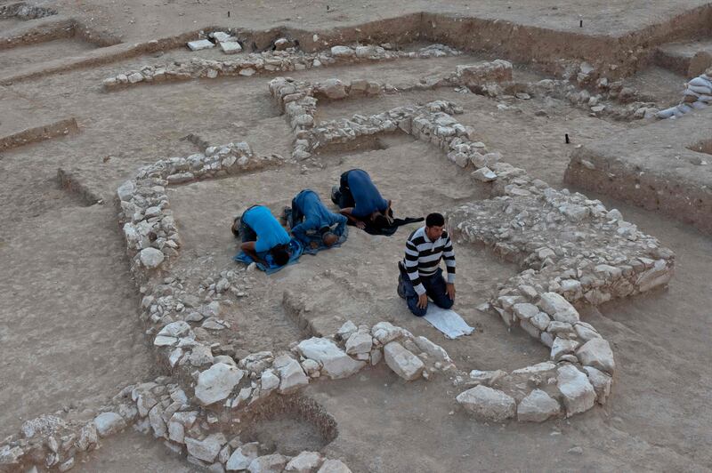 Israel's Antiquities Authority workers pray amid the remains of the mosque.  