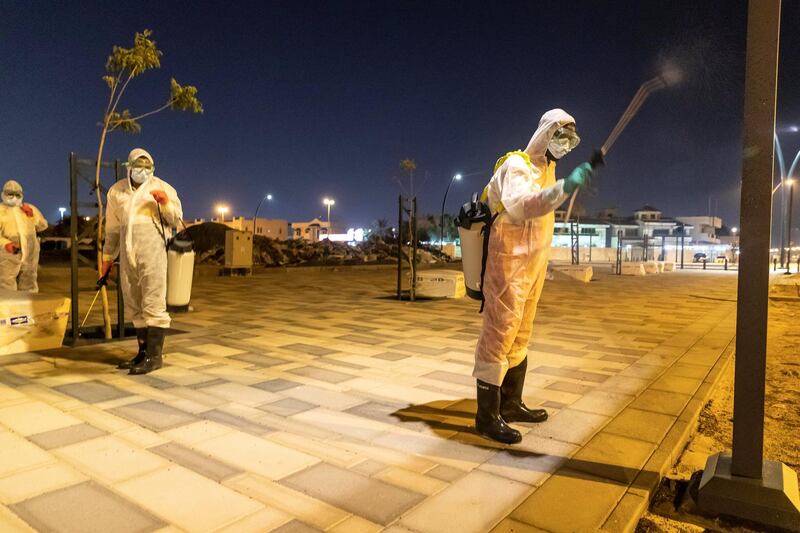 SHARJAH, UNITED ARAB EMIRATES. 26 MARCH 2020. Sharjah Municipal staff spray and disinfect the sidewalk along the Al Muntazah Str area of Sharjah near the Ajman border. . (Photo: Antonie Robertson/The National) Journalist: None. Section: National.