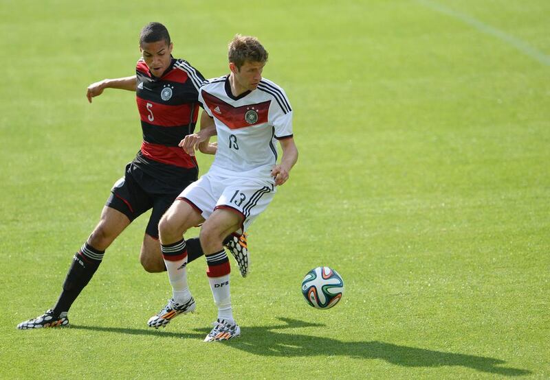 Germany's Thomas Muller, right, and Malcolm Cacutalua of the German U-20 team vie for the ball  during a practice match on Sunday. Andreas Gebert / EPA / May 25, 2014