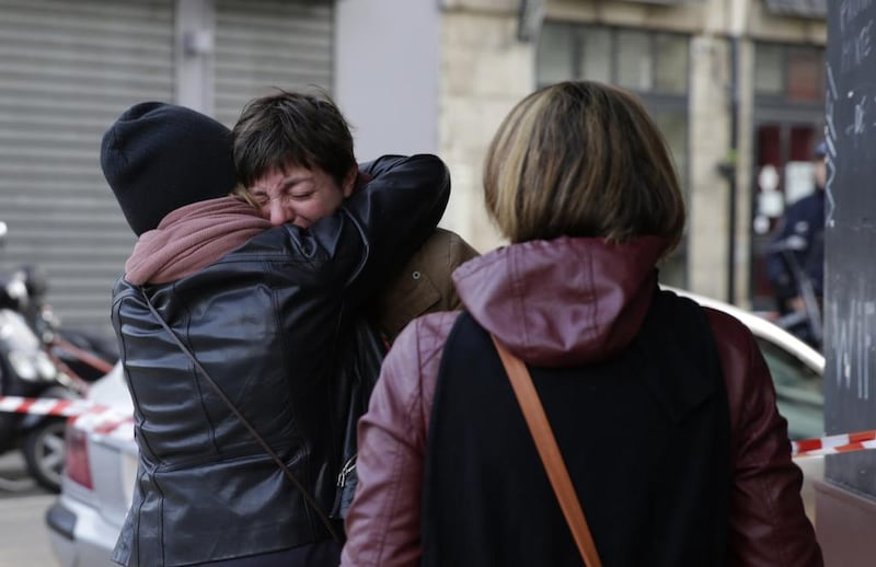 Mourners gather outside of the Carillon bar in the 10th district of Paris. Le Petit Cambodge, adjacent to the Carillon bar, was the scene of one of the attacks overnight. Kenzo Tribouillard/AFP Photo
