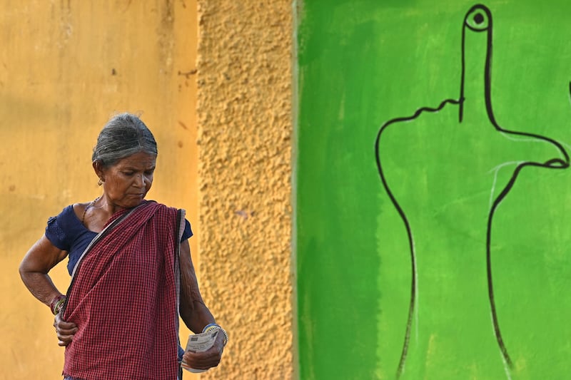 A voter in Dugeli village, Chhattisgarh state, waits to cast her ballot at a polling station during the first phase of voting of India's general election. AFP