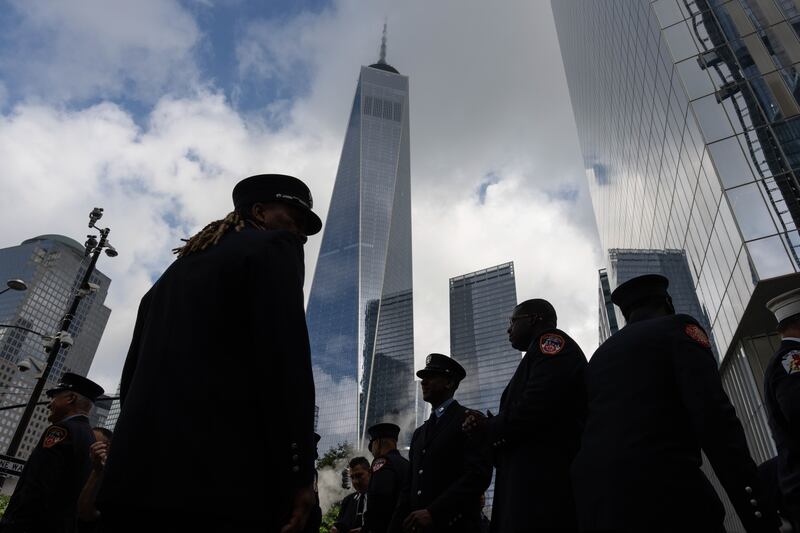 Firefighters stand near the National September 11 Memorial during an annual ceremony to commemorate the 22nd anniversary of the September 11, 2001, terrorist attacks. EPA