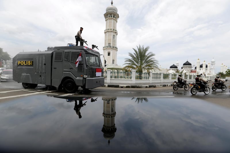 A police water cannon truck sprays disinfectant in the streets to curb the spread of coronavirus in Banda Aceh, Indonesia. EPA