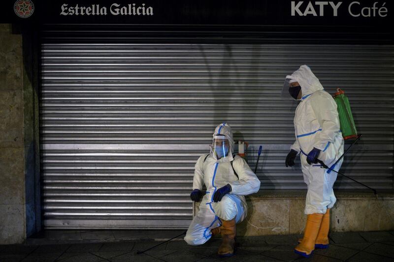 Two cleaning workers disinfect the streets of Ourense, in Galicia, northwestern Spain. EPA