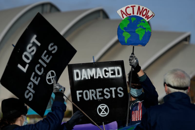 Extinction Rebellion activists holds placards at Cop26 last year in Glasgow, Scotland. AP Photo