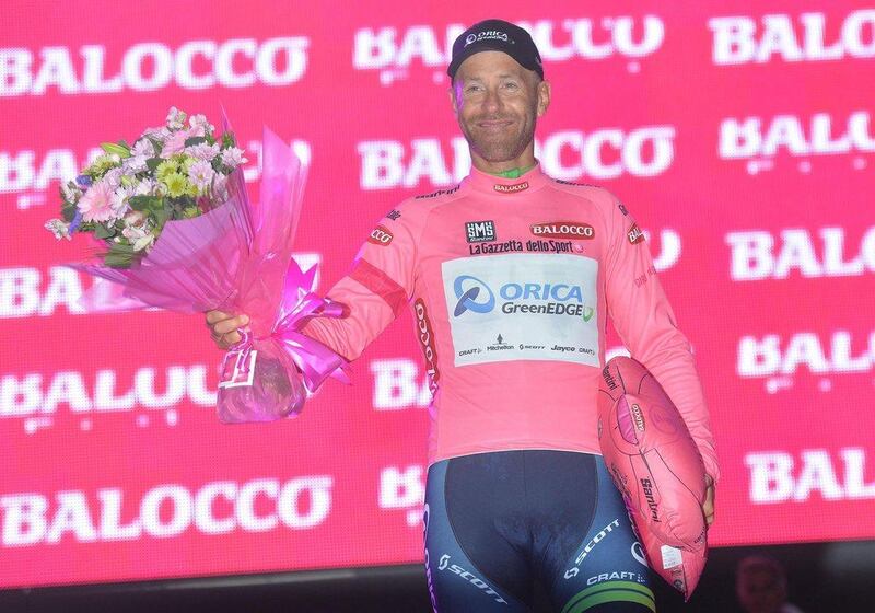 Canadian rider Svein Tuft of the Orica GreenEdge team wears the overall leader's pink jersey as he celebrates on the podium after his team won the first stage of the 2014 Giro d'Italia in Belfast on Friday. Luca Zennaro / EPA