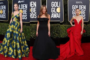 (L-R) Taylor Swift, Jennifer Aniston and Scarlett Johansson pose on the Golden Globes red carpet in LA.
