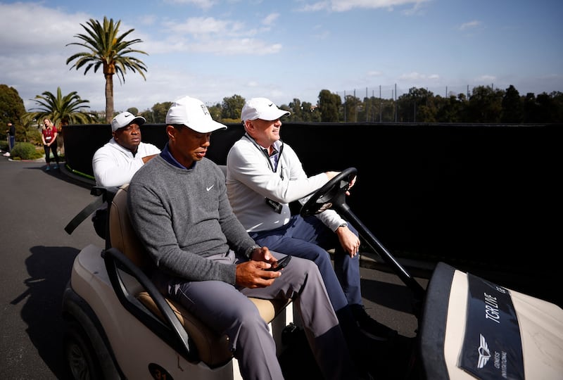 Tiger Woods and Rob McNamara, executive vice president at TGR, ride in a cart at Riviera Country Club. Getty