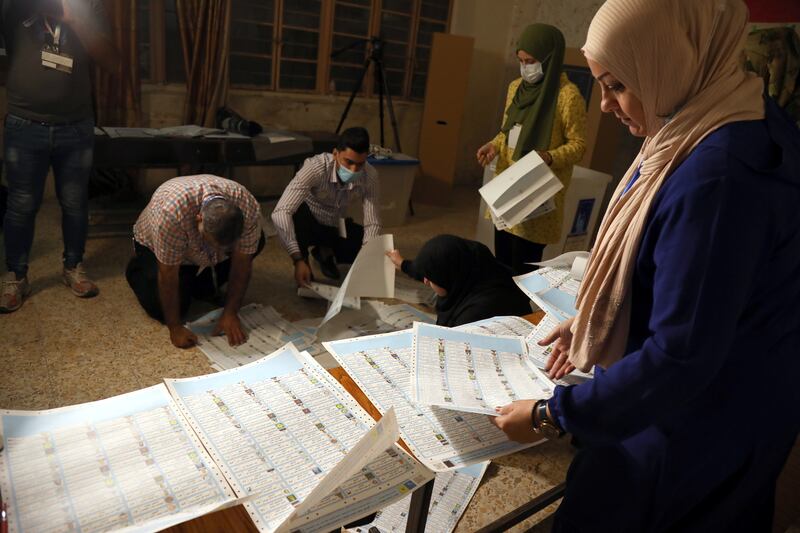 Iraqi election committee staff members count votes at the end of the parliamentary election day at a polling station in Baghdad's Karada district. EPA