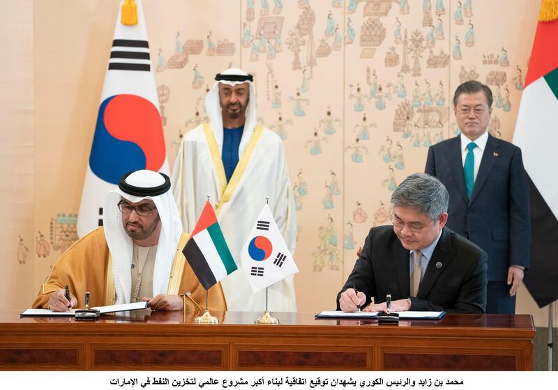 SEOUL, REPUBLIC OF KOREA (SOUTH KOREA)  - February 27, 2019: HH Sheikh Mohamed bin Zayed Al Nahyan, Crown Prince of Abu Dhabi and Deputy Supreme Commander of the UAE Armed Forces (back L) and Moon Jae-in, President of the Republic of Korea (South Korea) (back R), witness an MOU signing ceremony between ADNOC and SKEC to build the world's largest crude oil storage facility in Fujairah, at the Blue House. Seen signing on behalf of the UAE is HE Dr Sultan Ahmed Al Jaber, UAE Minister of State, Chairman of Masdar and CEO of ADNOC Group (L) and a Korean representative of SKEC (R). 

( Rashed Al Mansoori / Ministry of Presidential Affairs )
---