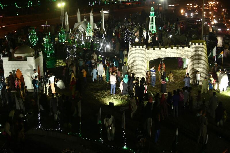 People visiting illuminated model representations of the Faisal Mosque ahead of Pakistan Independence Day celebrations in Karachi.  EPA